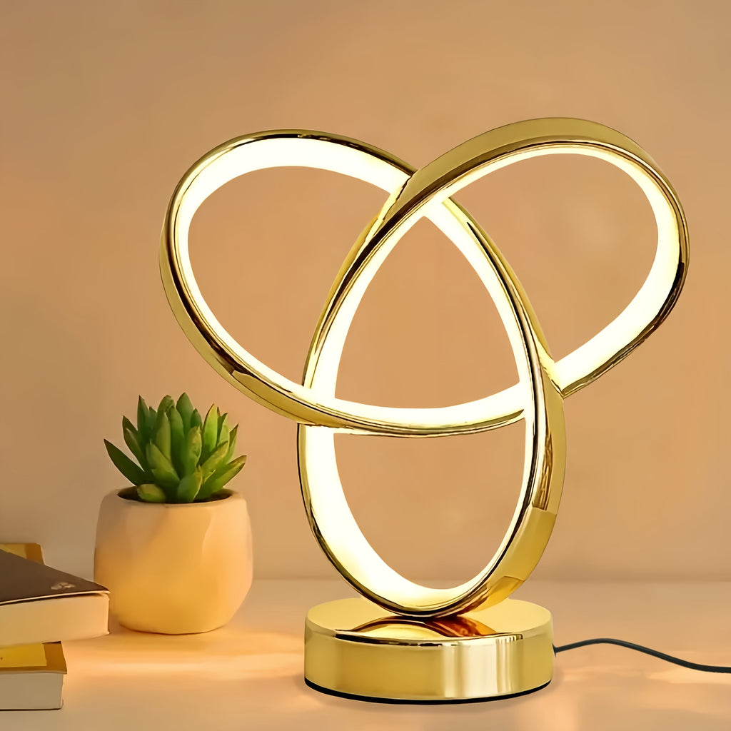 Lámpara de Escritorio LED Anillo Möbius Tricolor vista frontal con la luz cálida encendida