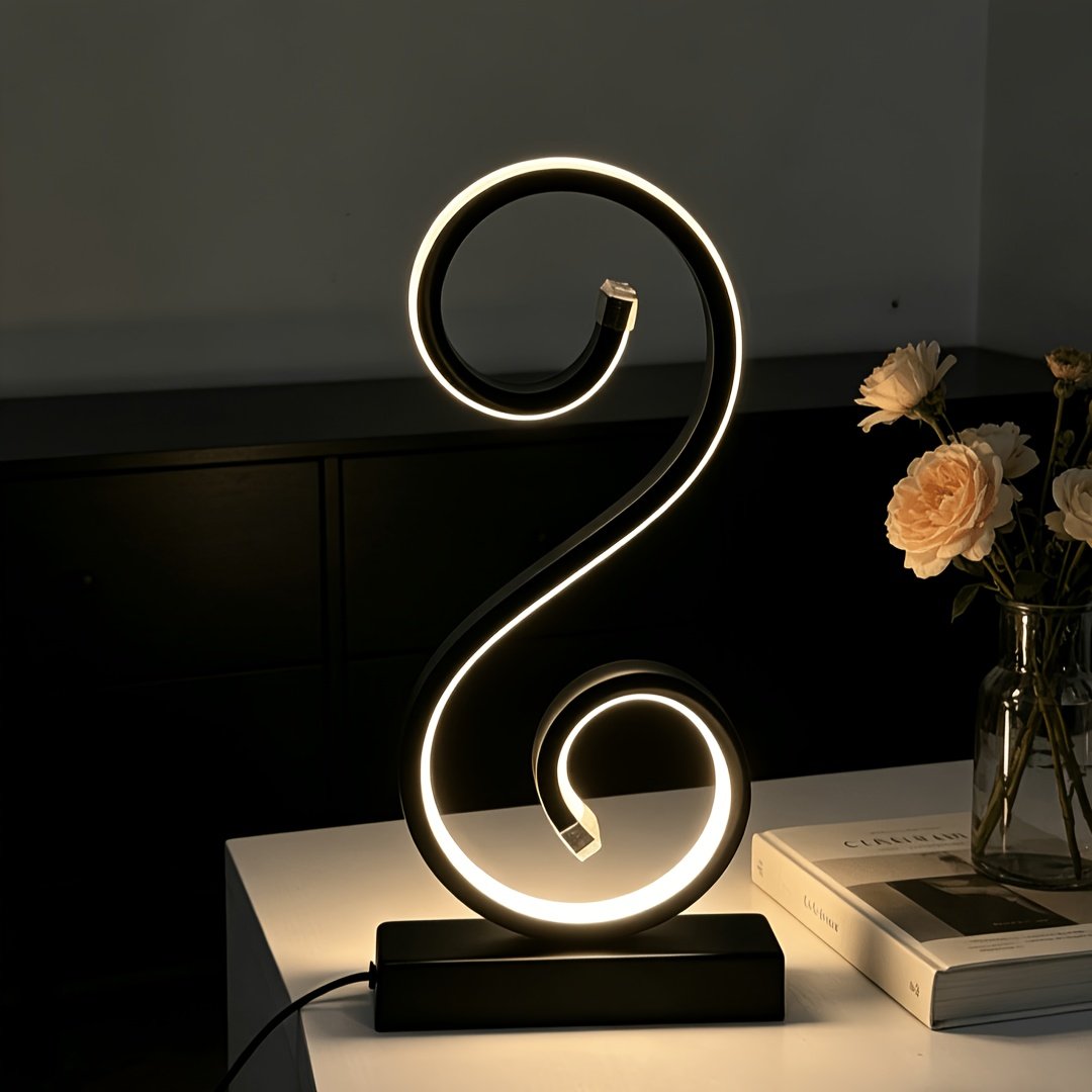 Lámpara de Mesa LED Espiral en S Negra USB apagada sobre un buró junto a la cama