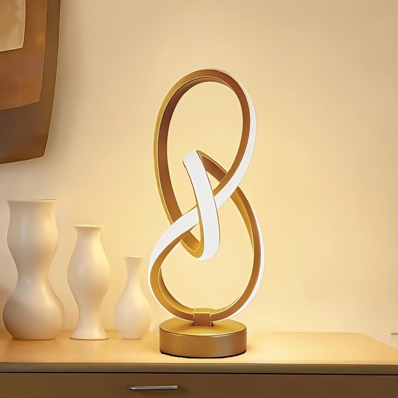 Lámpara de Escritorio Espiral USB Negra y Dorada vista frontal con la luz cálida encendida