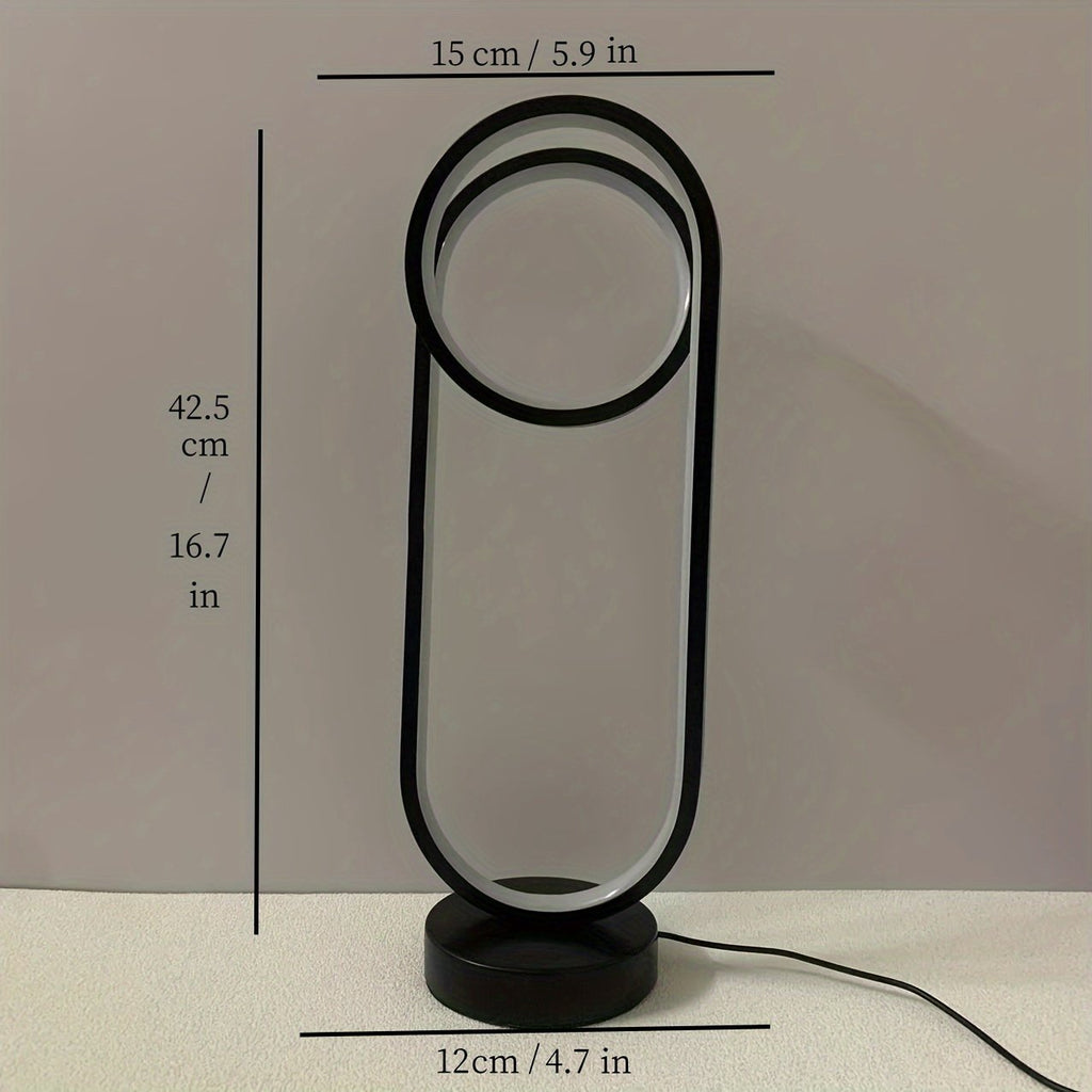 Lámpara de Mesa LED Doble Anillo USB Regulable apagada sobre un buró junto a la cama